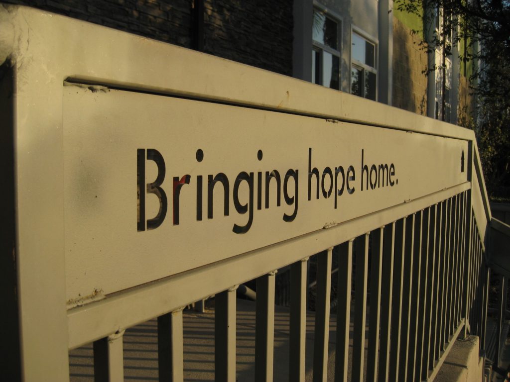 Photo of railing etched with the message, "Bringing hope home."