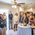 Executive Director Melissa Peterman addresses a gathering of people in attendance of the Meade Avenue Housewarming.